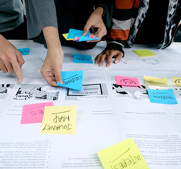 Team workshop mapping workflows with sticky notes